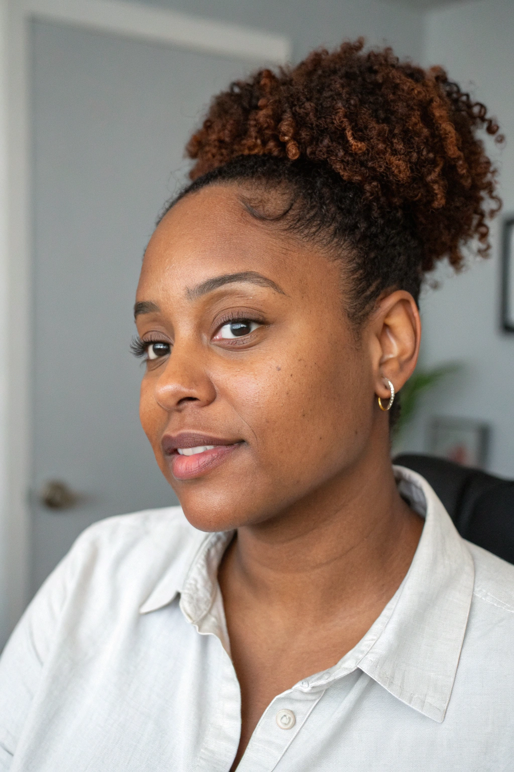 12. Low bun with curly bang