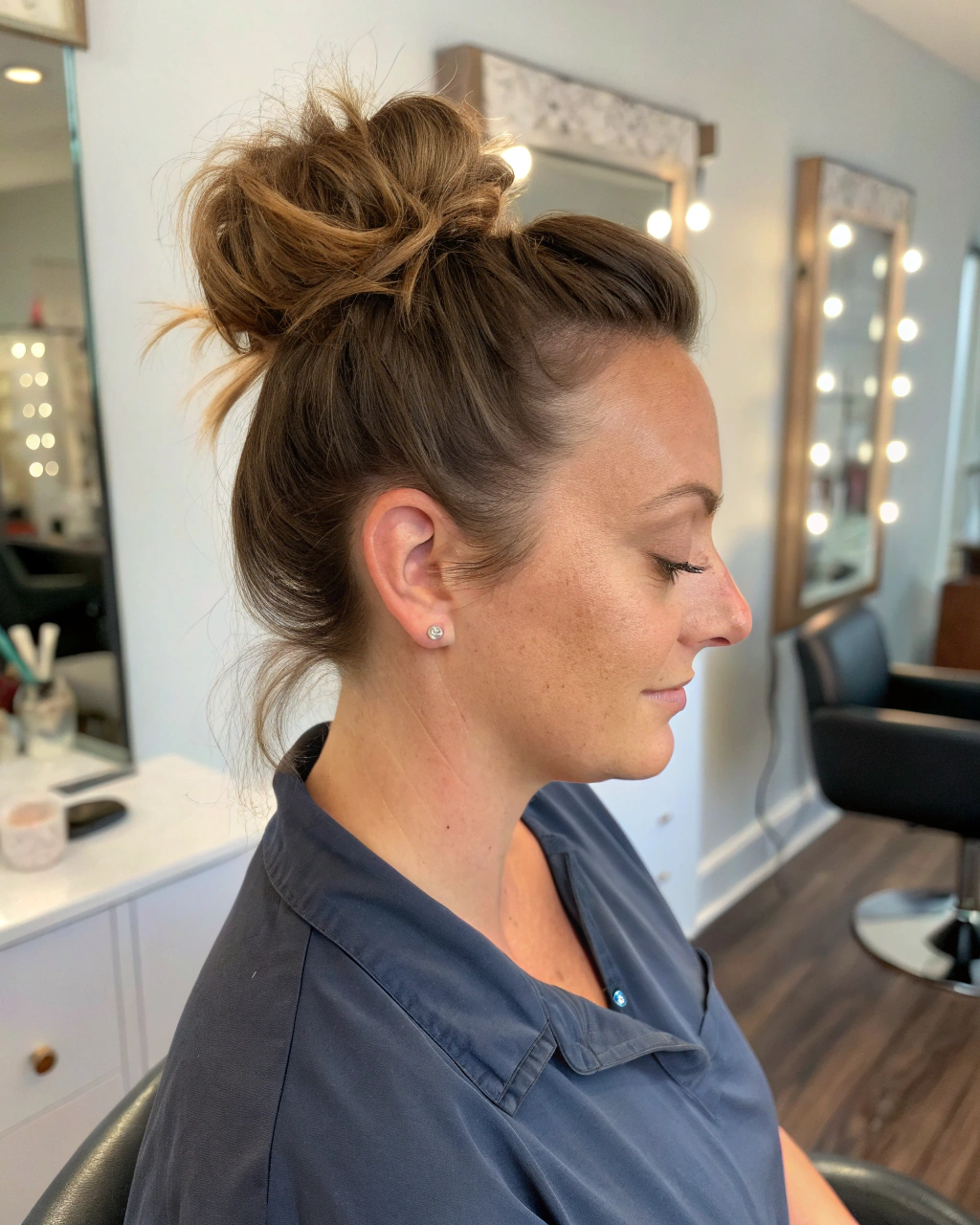 3. Messy bun with face-framing pieces