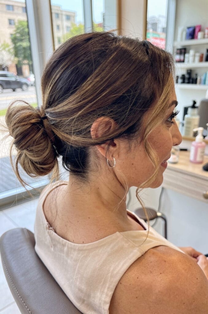 Messy low bun with tendrils