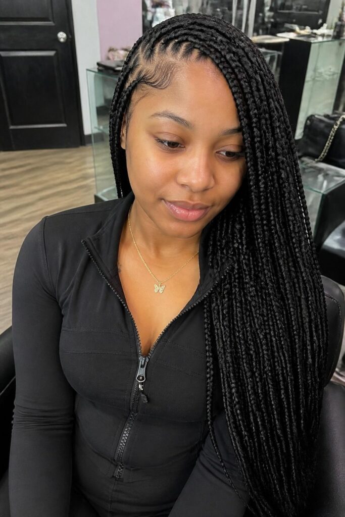 Large knotless box braids with a side swept part