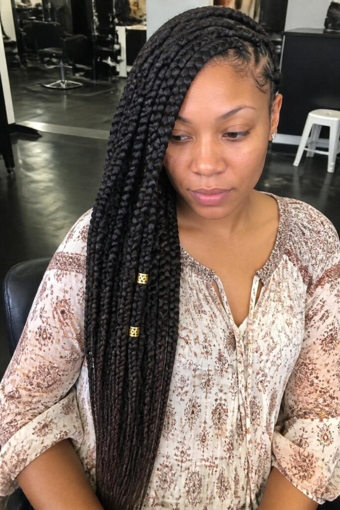 Large knotless braids with a deep side sweep and cuffs