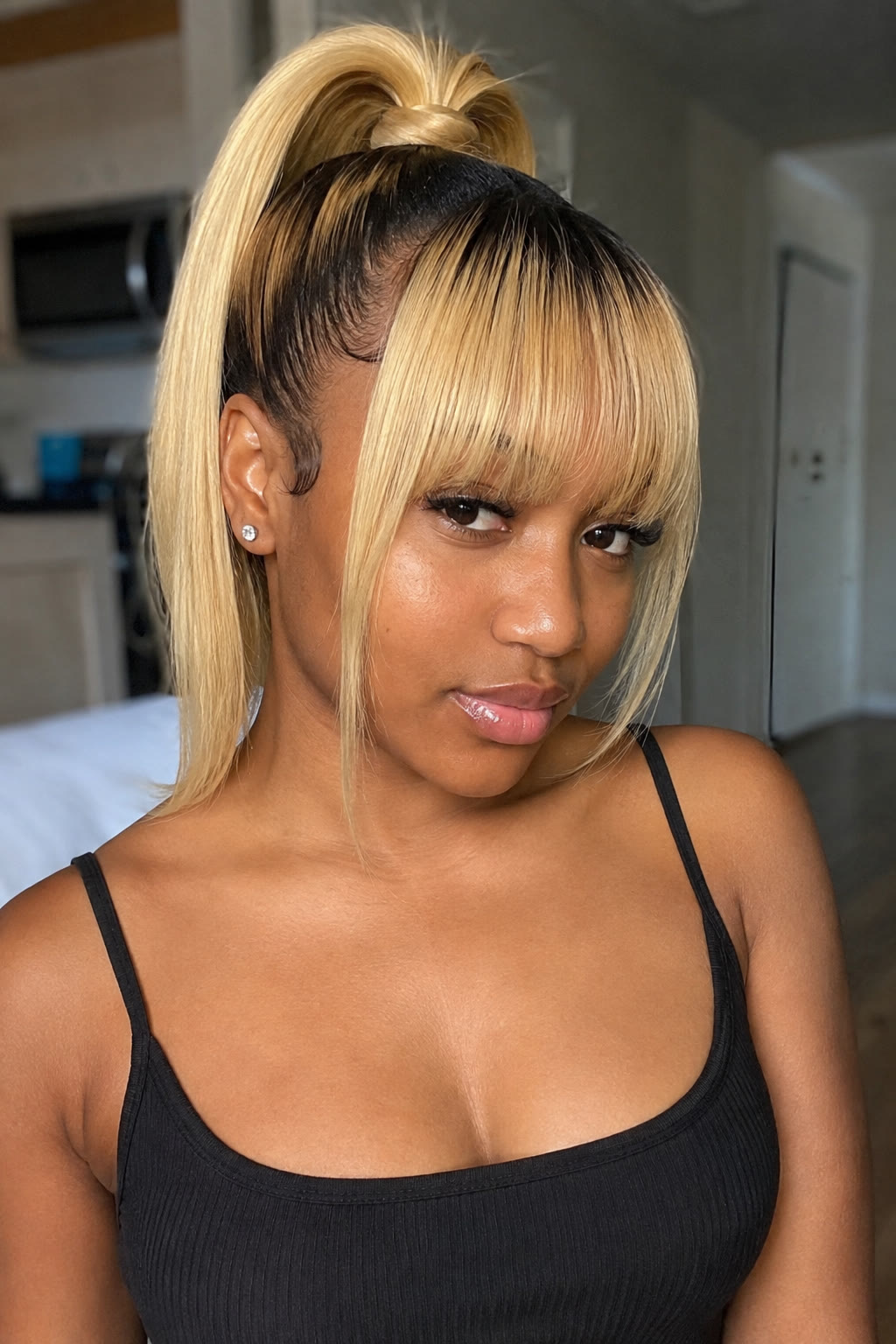 14. Blonde high ponytail with bangs