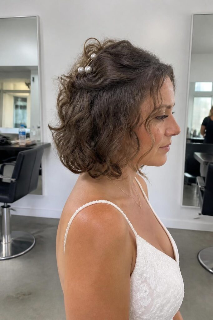 Half up half down curly bob with pearl pins