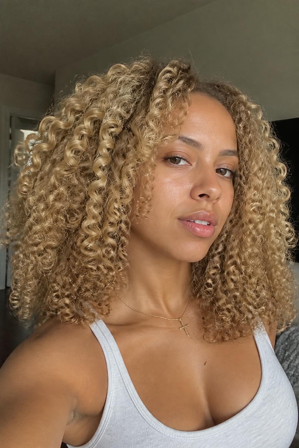 Woman with honey blonde wash-and-go curls