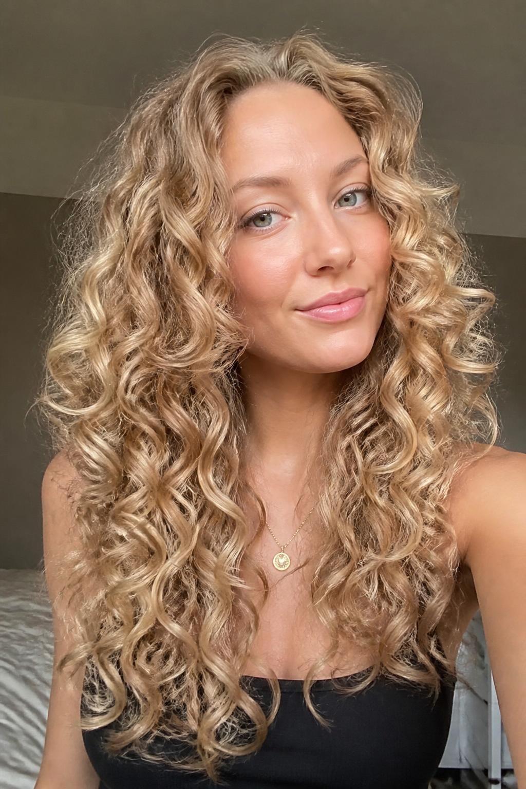 Woman with champagne blonde spiral curls