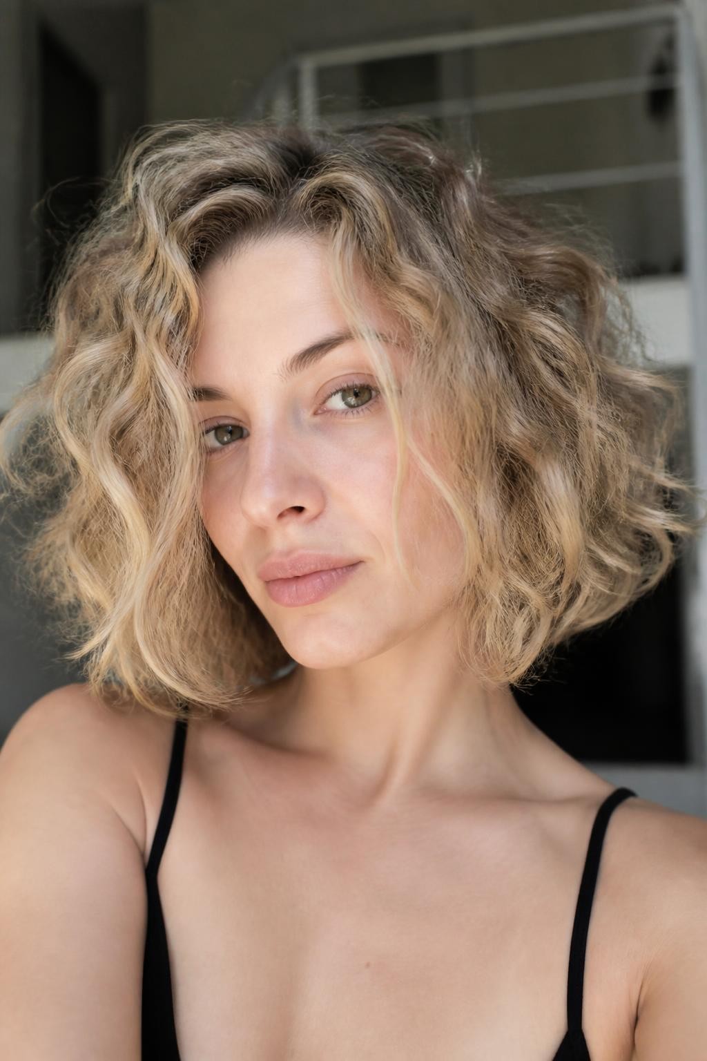 Woman with dirty blonde curly bob