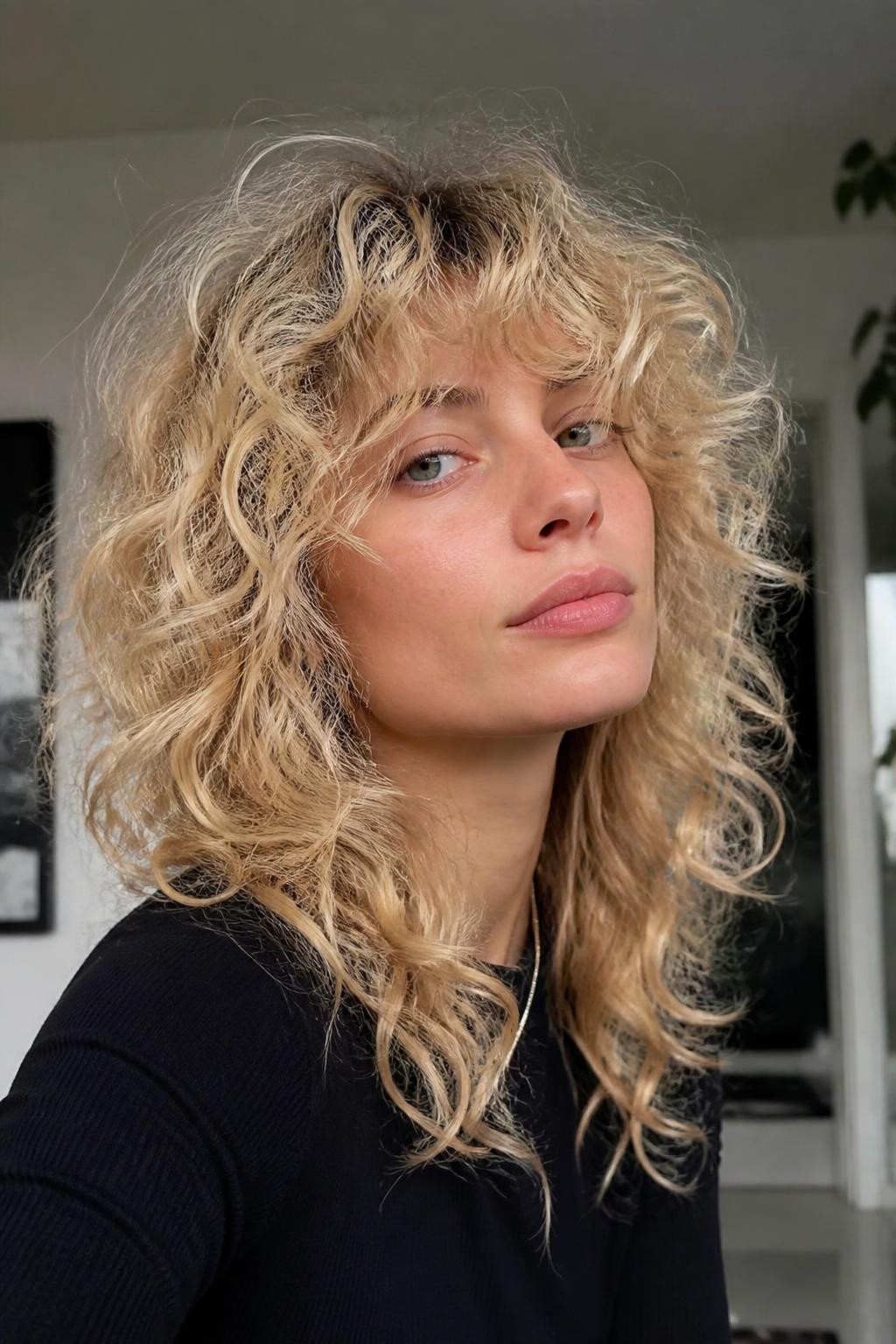 Woman with ash blonde curly shag