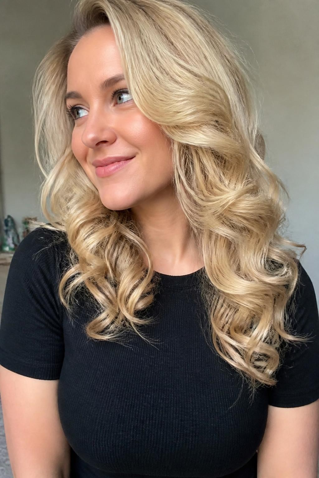 Woman with bright blonde layered curls