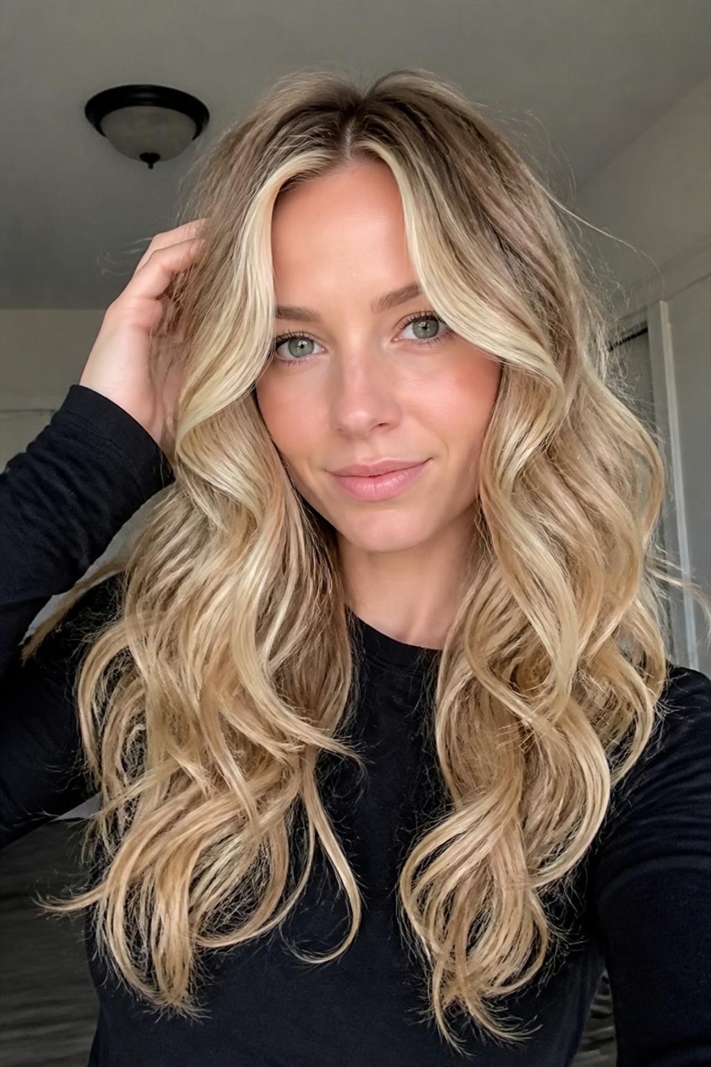 Woman with soft blonde curls with money piece