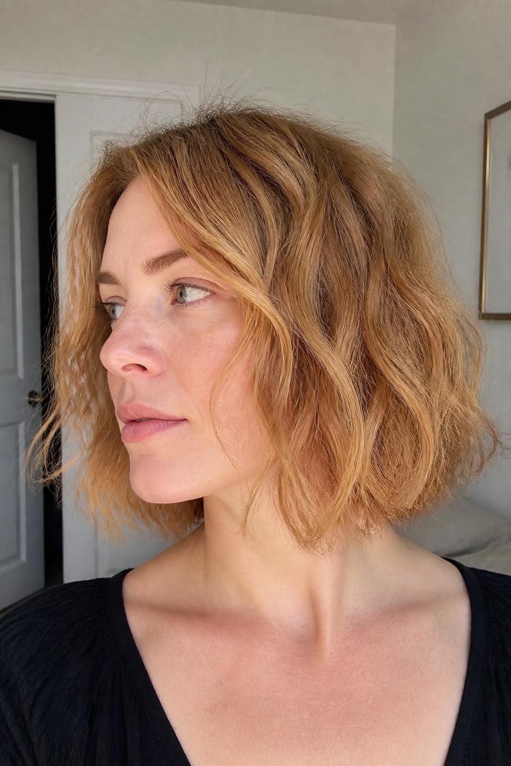 Woman with tousled wavy bob on frizzy wavy hair, not sleek, not stacked, not shaggy bob