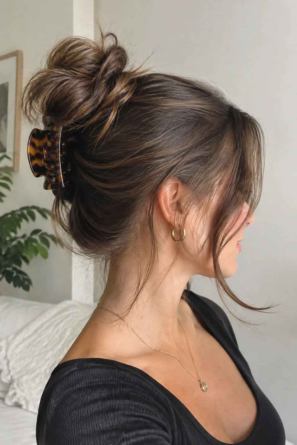 The Messy Topknot with Face-Framing Tendrils hairstyle