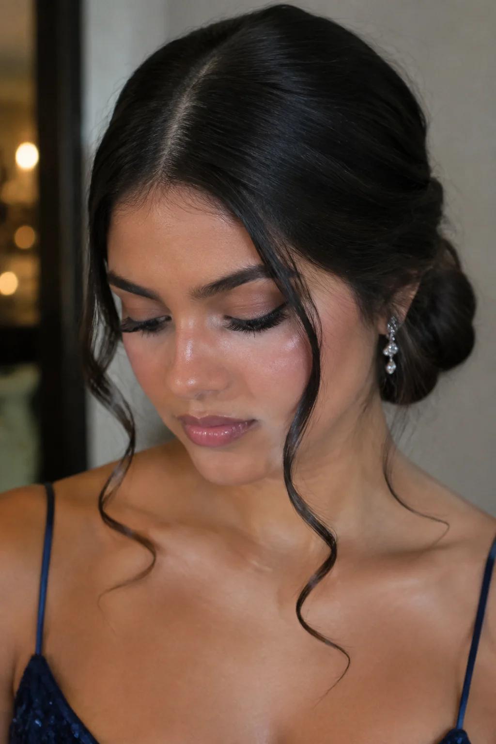 Low Bun with Face-Framing Tendrils hairstyle