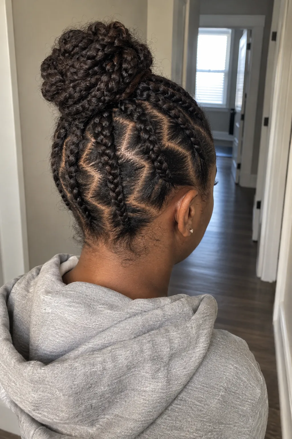Zigzag Part Cornrows With a Bun hairstyle