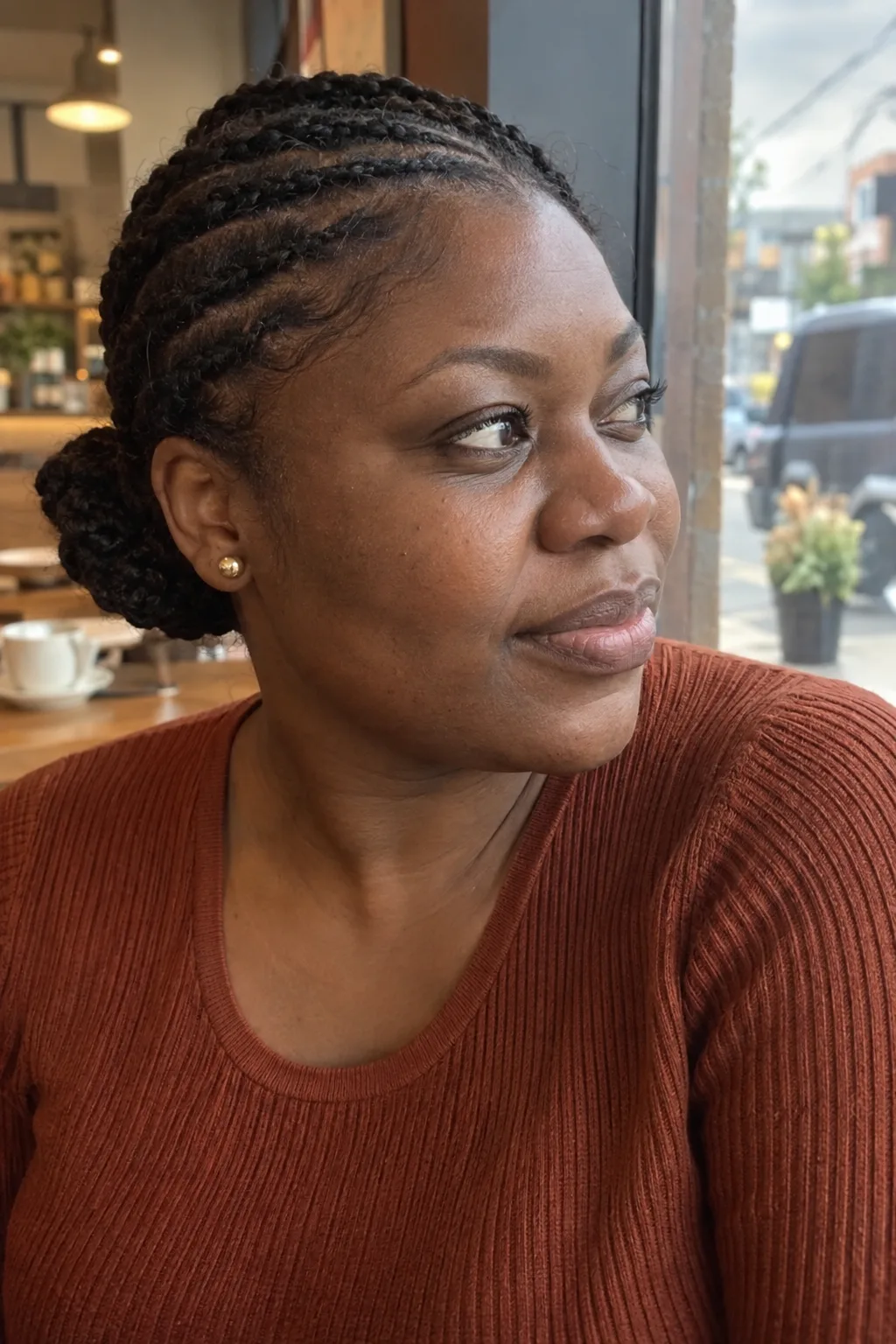 Side-Swept Cornrows Into a Side Bun hairstyle